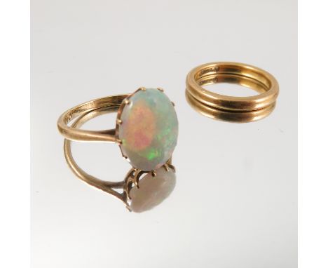 An opal single stone ring, stamped '9ct', finger size L, and a 9 carat gold wedding ring, 5.1g gross