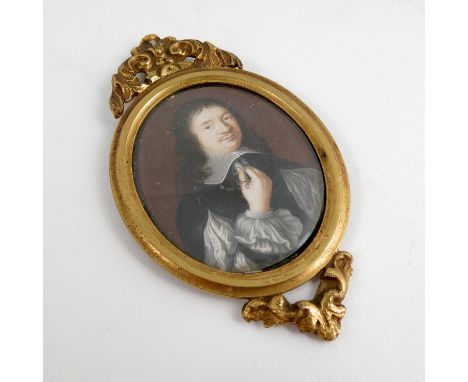 An oval portrait miniature, of Oliver Cromwell, inscribed verso, in gilt metal frame with scroll decoration, maximum diameter