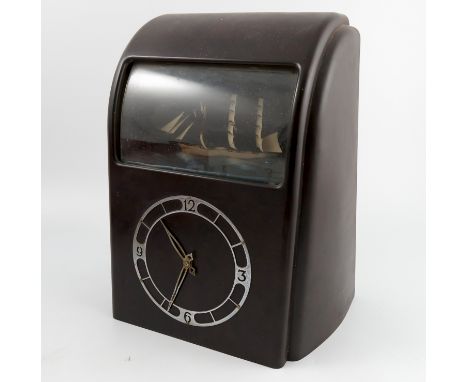 A Vitascope Industries Ltd bakelite cased Art Deco style electric ship automata clock, the brown case with a curved front and