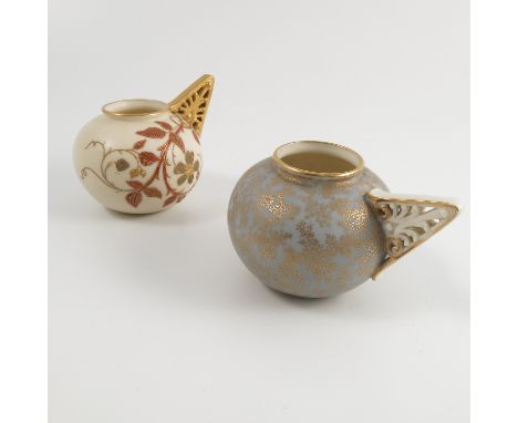Two Royal Worcester vases, of circular form with pierced triangular side handle, one decorated with a seaweed pattern to a bl