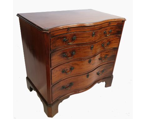 A Georgian design mahogany serpentine fronted chest, having a cross banded top with brushing slide below, and four graduated 
