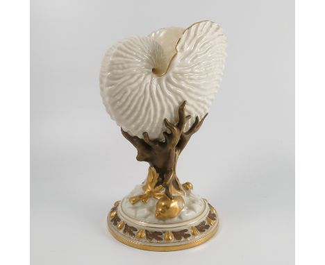 A Royal Worcester centre piece, formed as a shell supported on coral to a circular base moulded with shells, in white and gol