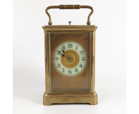 A brass cased repeating carriage clock, with gilt metal dial and white enamel chapter ring, height including handle 7ins