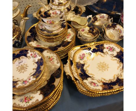 A Coalport part dessert service, decorated with reserves of flowers with panels of blue and gilt decoration, comprising eight