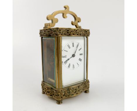 A French brass cased carriage clock, the movement stamped R & Co Made in Paris, the base decorated with scroll bands, height 