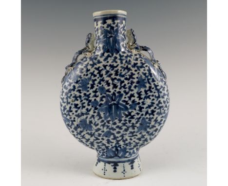 A Chinese moon flask vase, decorated with flower head and dragon mask handles, height 9.75ins Condition report: Appears good 
