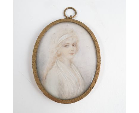 An oval portrait miniature, of a girl with loose hair in a band and wearing a white dress, in engraved yellow metal frame, ma
