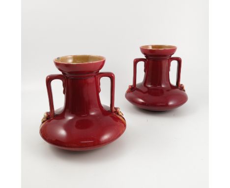 A pair of Linthorpe Pottery vases, designed by Christopher Dresser, with a pair of angular handles and squat body, decorated 