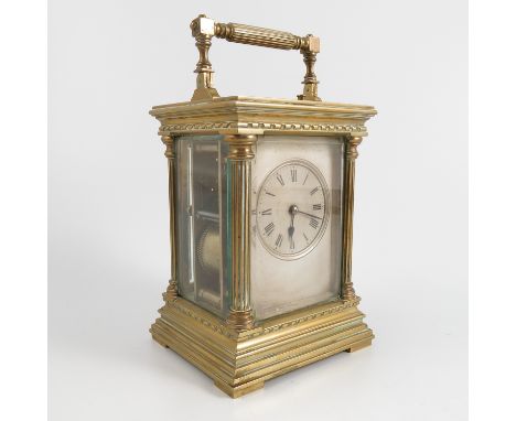 A brass cased repeating carriage clock, with silvered dial, the movement stamped E.M & Co. height including handle 7.75ins