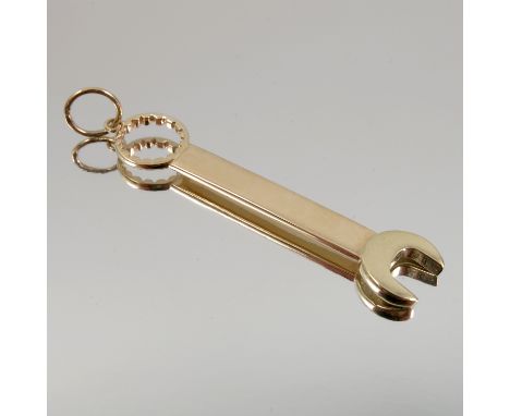 A 9ct gold charm, modelled as a spanner, with suspension loop, weight 4.8g