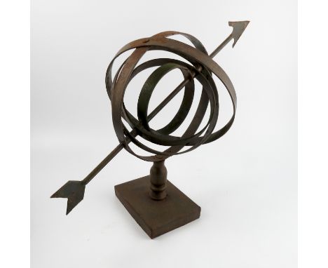 A metal Armillary Arrow Sphere, raised on a rectangular base, height 16.5ins