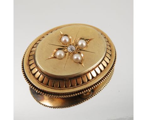 A Victorian diamond and split pearl locket back gold brooch, unmarked, the central old cut stone of approximately 0.12 carats