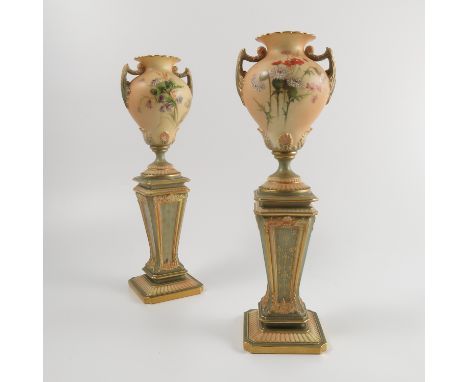 A pair of Royal Worcester blush ivory vases, the vase decorated with thistles and flowers mounted on a classical column, shap