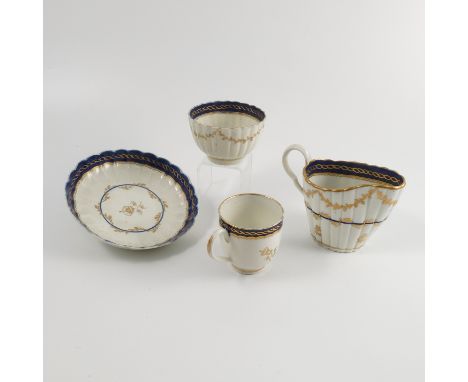 A group of first period Worcester porcelain, all decorated in bands of blue and gilt garlands to a reeded body, comprising a 