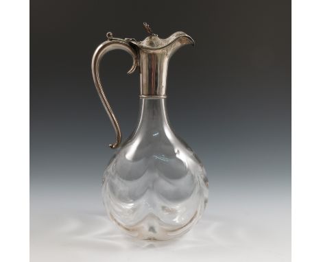 A silver and glass claret jug, with bulbous ripple glass body, the silver mount with acanthus leaf thumb piece, London 1898, 
