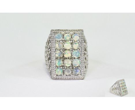 Opal Rectangular Cluster Ring, a rectangle of round cut opals, totalling 3cts, set in a criss-cross openwork, wide shouldered