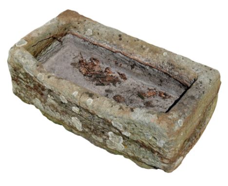 A weathered stone trough of rectangular form, 41 by 80 by 33cm high. 