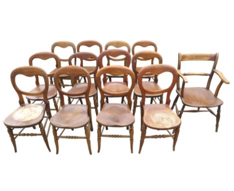 A composite set of twelve Edwardian stained beech balloon back dining chairs, being two sets of six, with solid shaped seats,