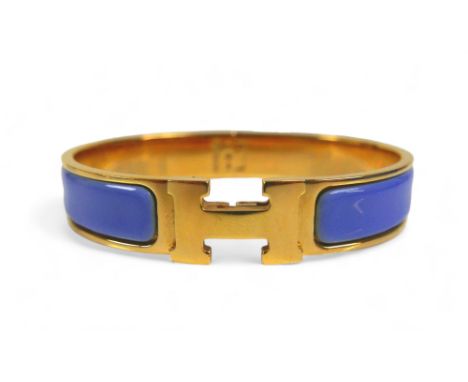 A Hermes Clac H gold plated hinged bangle, with blue enamel details, H design clasp. 