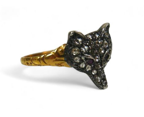 A Victorian diamond and ruby fox head ring, 22 rose cut diamonds cover the face with two ruby chips for eyes, with fine flora