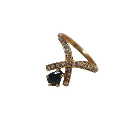 An 18ct gold sapphire and diamond crossover ring, pear cut sapphire approximately 5 by 4mm, size H/I, 3.3g. 