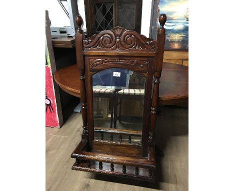 A WALL MIRROR WITH SHELF