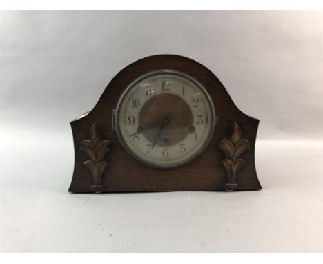 TWO EARLY 20TH CENTURY CLOCKS, one a wall mounted bakelite example 25cm high, the other a mantel clock, 30cm wide