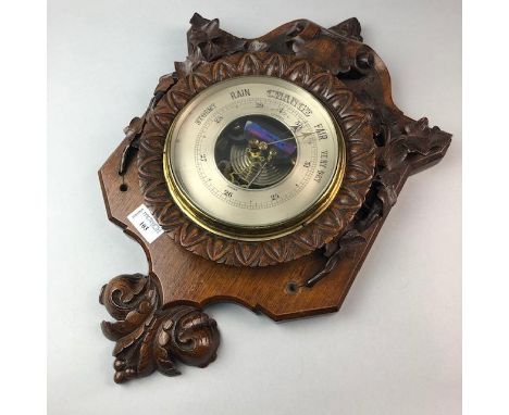 ANEROID BAROMETER, in carved oak frame