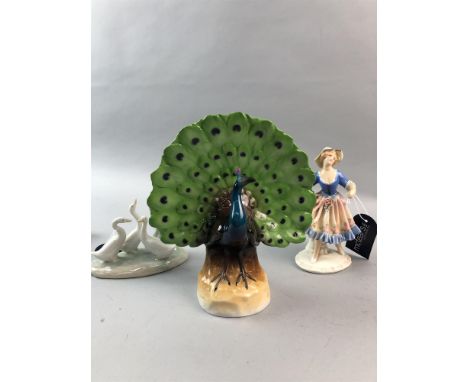 GERMAN PORCELAIN FIGURE OF A PEACOCK IN FULL DISPLAY, 20cm high, along with two Russian ceramic figures of pandas, a Lladro w