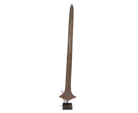 A Topoke currency blade liganda Democratic Republic of the Congo iron, with remains of a light blue paint, 151.4cm high, on a