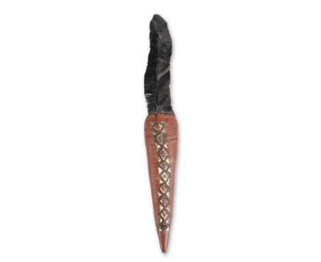 An Admiralty Islands fighting dagger Melanesia with an obsidian blade and a gum covered handle with differing carved lozenge 