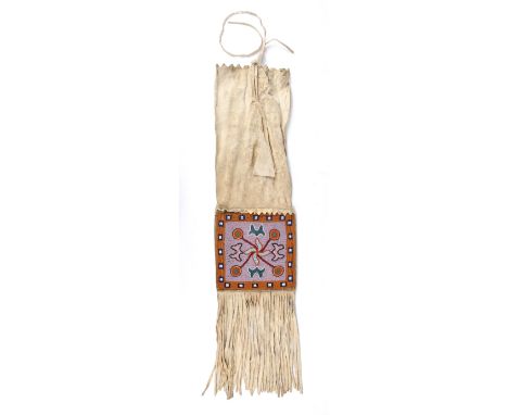 A Stoney or Plains Cree pipe bag Canadian Plains buckskin, cloth and coloured glass beads with matching stylised foliate pane