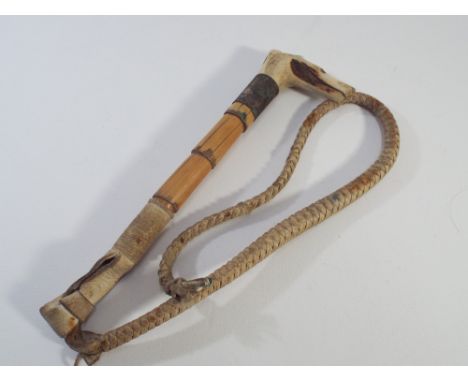 Bamboo and horn mounted hunting whip, the handle carved as a dogs head with inset whistle 