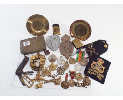A collection of military items to include First World War Christmas tin, military medals and trench art etc