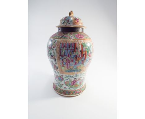 Large 19th century Chinese famille rose vase and cover, painted with interior scenes within reserves, lid with dog of fo fini