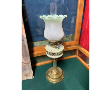 A Victorian Glass and brass paraffin desk lamp. Designed with a brass column base, green glass body with hand painted floral 