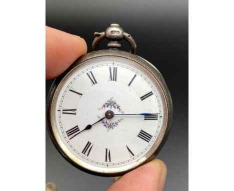 A Birmingham silver cased pocket watch designed with an enamel face. Comes with two keys. [Spring may need replacing] 