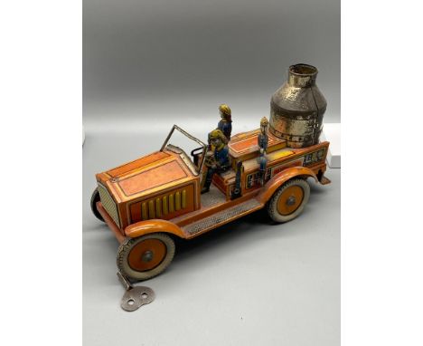 A German tinplate clockwork sparking fire engine. Possibly by Arnold with three tin firemen. In a working condition 