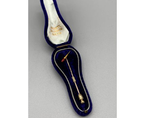 A Victorian gold tone and enamel pin. Detailed with a paint brush top with a red enamel tip. Comes with Mallett Goldsmith Bat