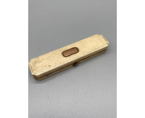 A ladies Victorian Ivory and gold rectangular compact with mirror and detailed with green upholstery. 