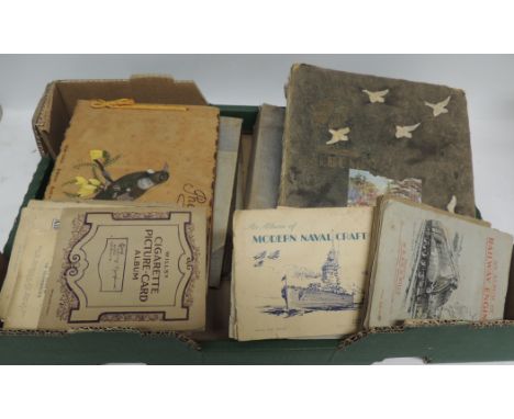 Two albums glued with postcards and images of churches and architectural features; a scrap book; adhesive albums of cigarette
