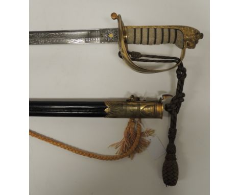 An Edward VII Royal Naval officers sword with presentation inscription, having lions head pommel, wirebound sharkskin grip, o