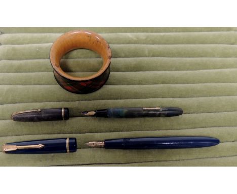 A Parker Slimfold fountain pen in dark blue case; a Conway Stewart "Dinkie" 560 fountain pen in green marbled case and a Tart