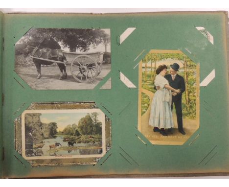 An album of approx 112 early 20th Century postcards including chromo litho greetings, Christmas, hold-to-the-light; photo top