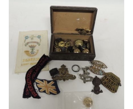 A WWI embroidered silk postcard Somerset Light Infantry together with a quantity of military cap badges, buttons; a trenchart