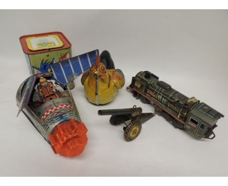 A Japanese tinplate battery operated US Apollo space capsule having opening flaps with astronaut inside; a Marx tinplate fiel