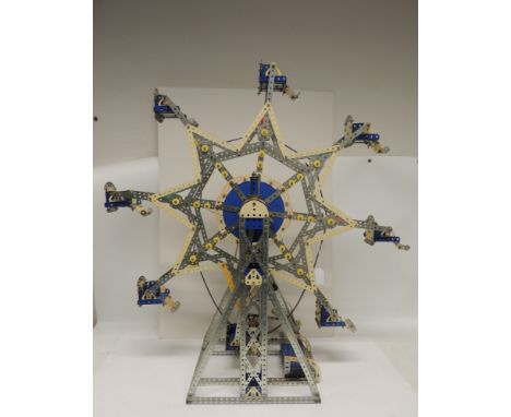 A Meccano mechanical display model of a fairground Big Wheel, having seats suspended from a revolving star shaped wheel with 
