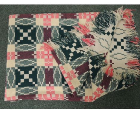 A vintage Welsh woven wool blanket, double sided geometric pattern in green/pink/cream approx 219cms x 153cms ++very small ar