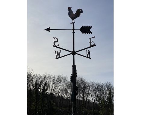 WROUGHT IRON WEATHER VANE having 'N', 'S', 'E' and 'W' pointers and a cockerel arrow, the column leaf decorated with square m