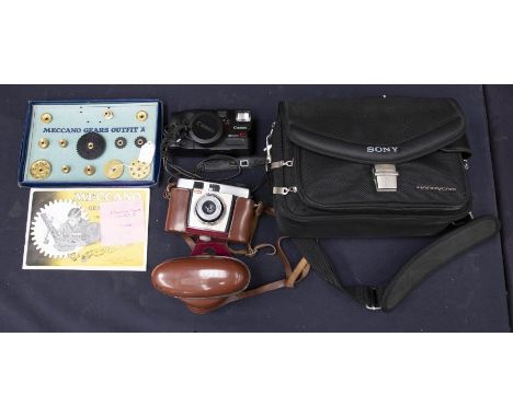 A Meccano Gears Outfit; a Kodak Brownie camera; a Canon camera; a cased set of postal scales